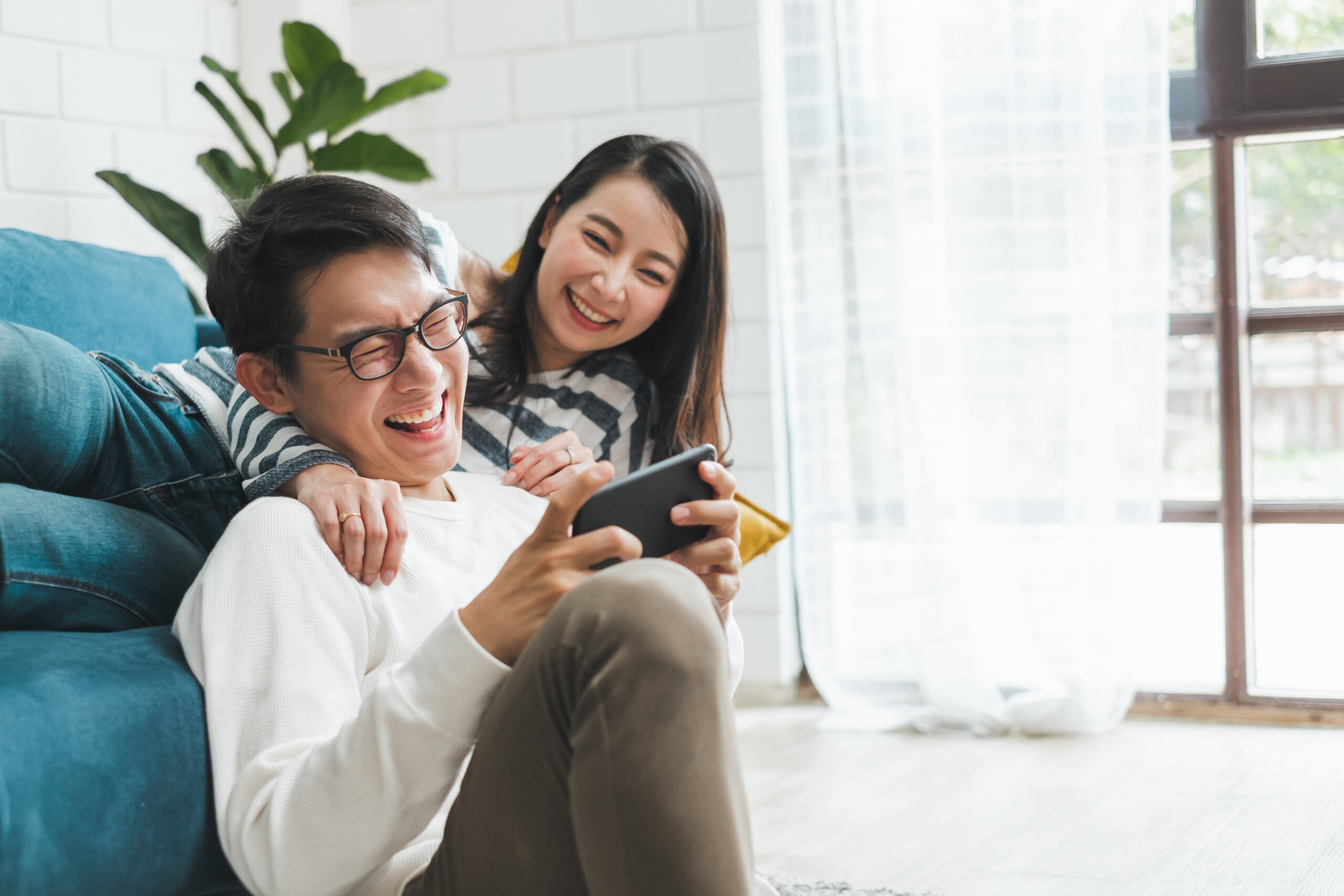 Couple on Couch looking at phone