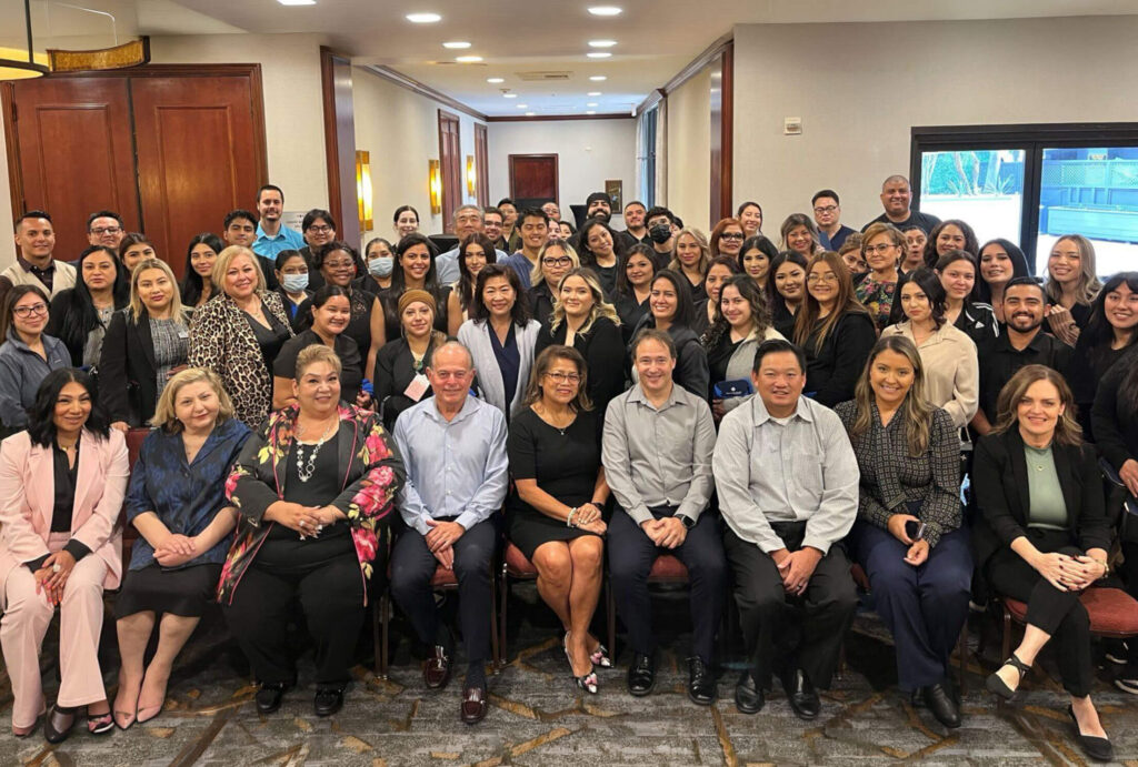 Group photo of the West Coast Dental Team gathered in a lobby
